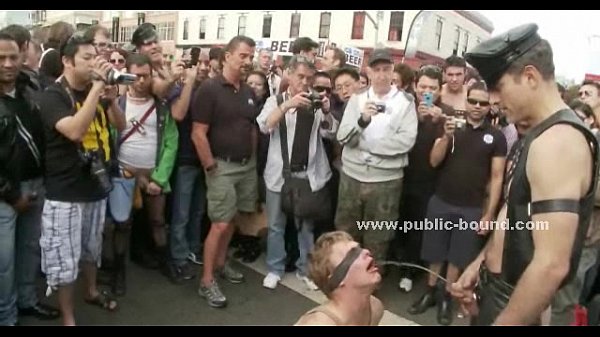 Gay slave tied with leather in group sex