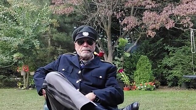 Military officer relaxes with pipe smoking